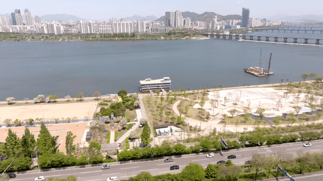 A cityscape with a river and high-rise buildings