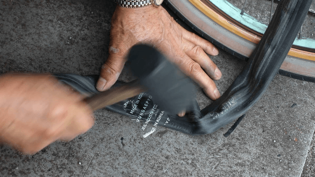 Repairing a bicycle tire with a hammer