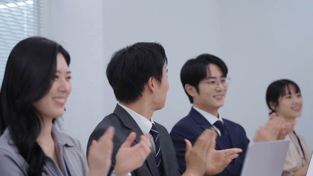 Business meeting with colleagues clapping