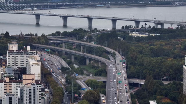 A bustling city highway with a bridge