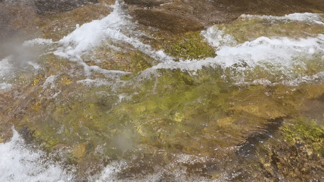 Clear valley flow spreading over shallow rock bed