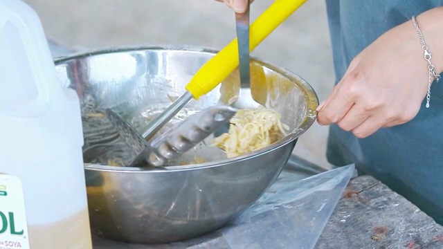 Mixing potato pancake batter in a metal bowl