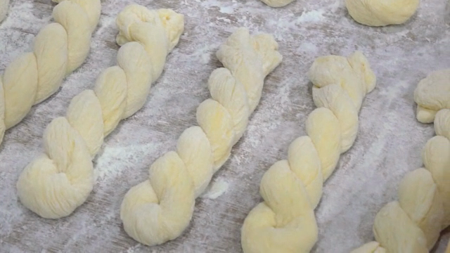 Twisted dough pieces on a floured surface