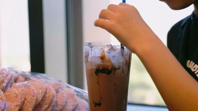 A person enjoying a chocolate latte