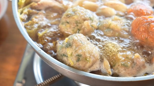 A pot of Korean hot pot with dumplings