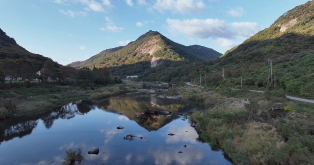 A tranquil river with mountains in the background