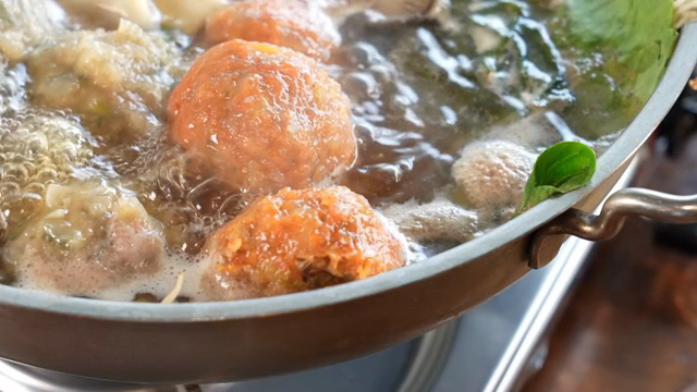 A pot of Korean hot pot with dumplings