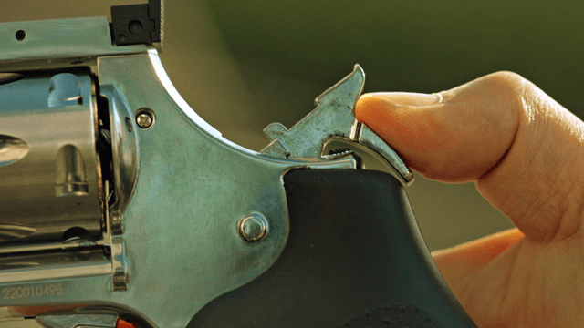 Close-up of a finger on a gun trigger