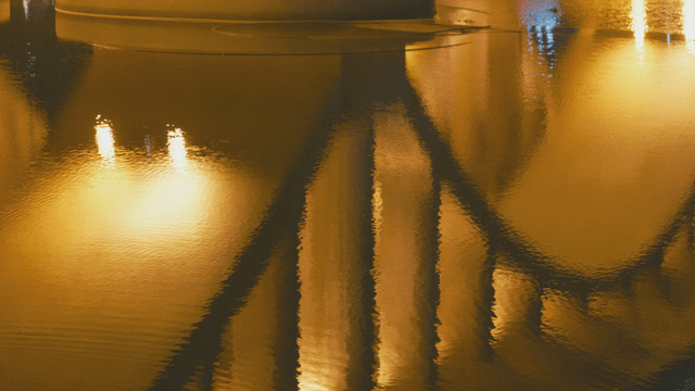 Night river lights illuminating bridge
