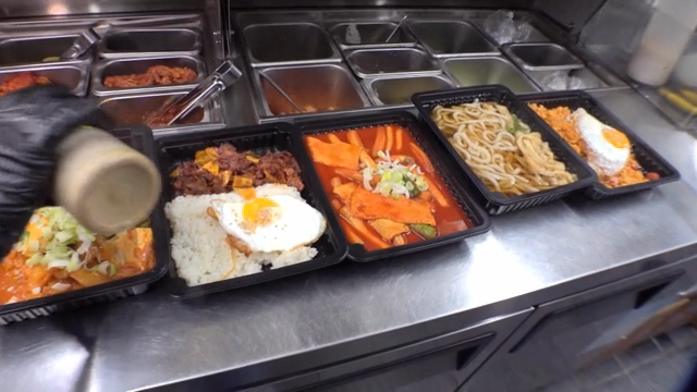 Various Korean dishes in black trays