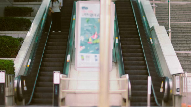 People using an escalator