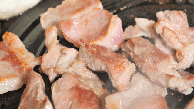Meat grilling on a hot pan