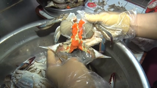 Cleaning crabs in a kitchen