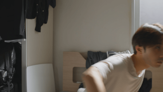 Man waking up in a sunlit room