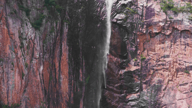 Waterfall flowing along rocky cliff