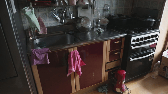 Cluttered kitchen with various utensils