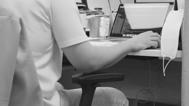 Person working on a laptop in an office