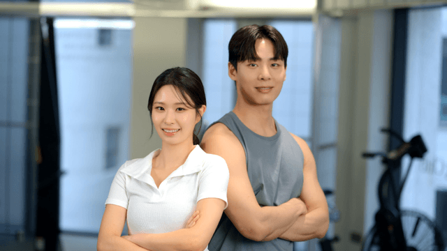 Confident couple posing with arms crossed at gym