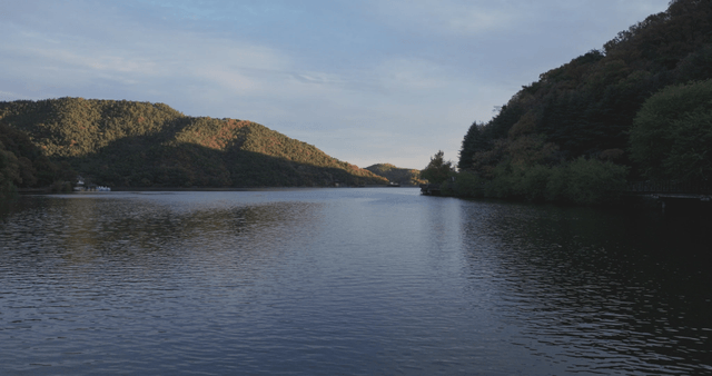 Tranquil lake surrounded by lush hills