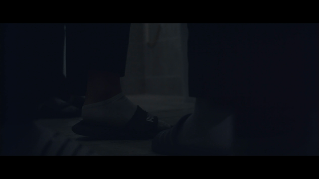 People standing indoors wearing slippers