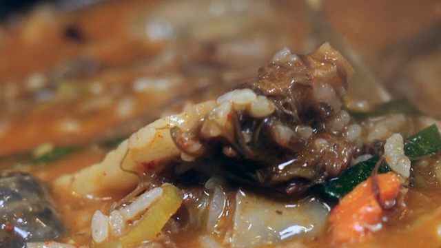 Sundae soup with bracken fern in a hot pot stirred with a spoon
