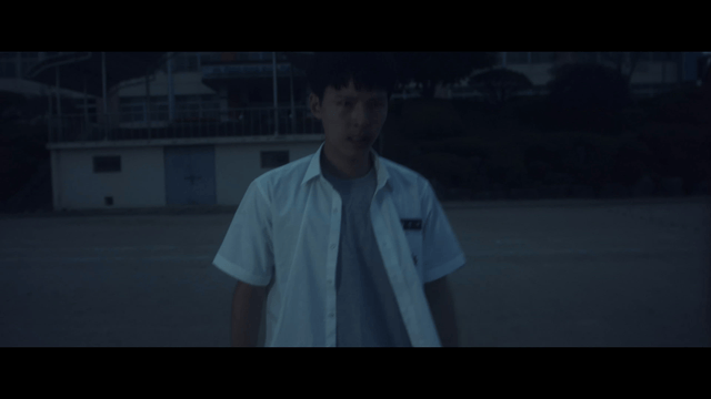 Angry student walking out of dark schoolyard