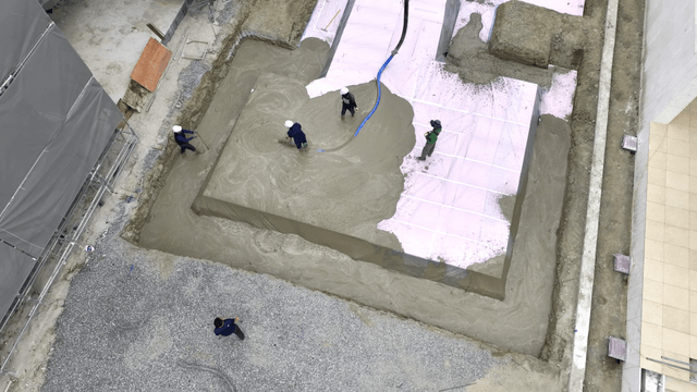 Construction workers pouring concrete