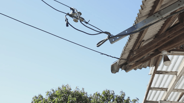 Rooftop with wires and clear sky