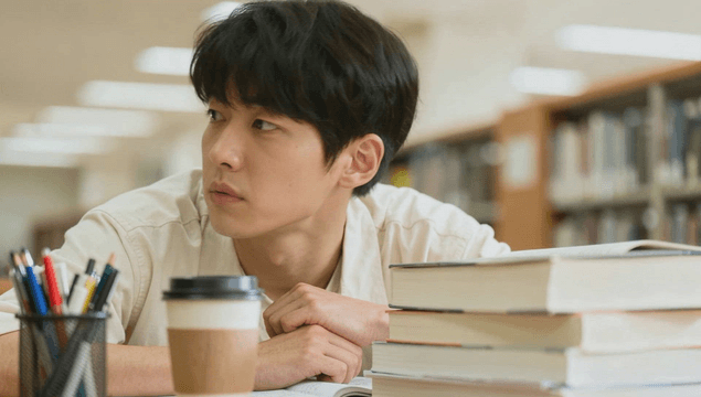 A young man studying in a library