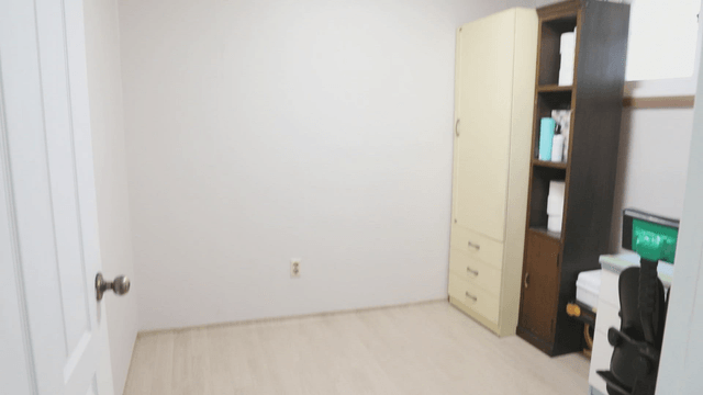 Small room with a bookshelf and chair