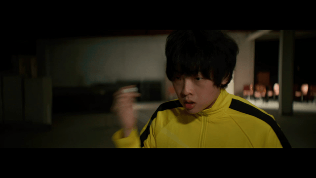 A person in a yellow tracksuit indoors