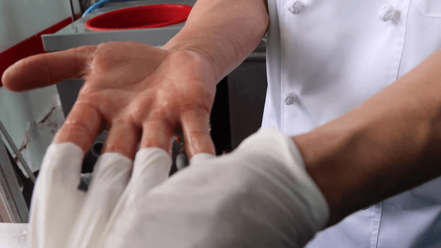 Person showing a hand after taking off a glove