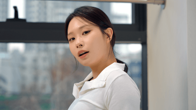 Young woman smiling while facing forward