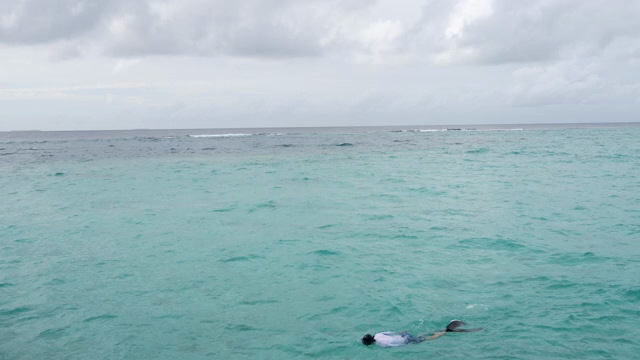 A person snorkeling in the open sea
