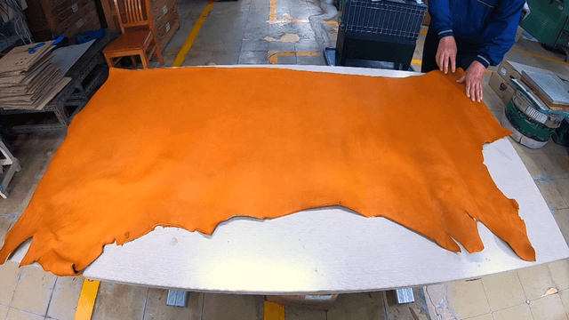 Brown wide leather inspected on table