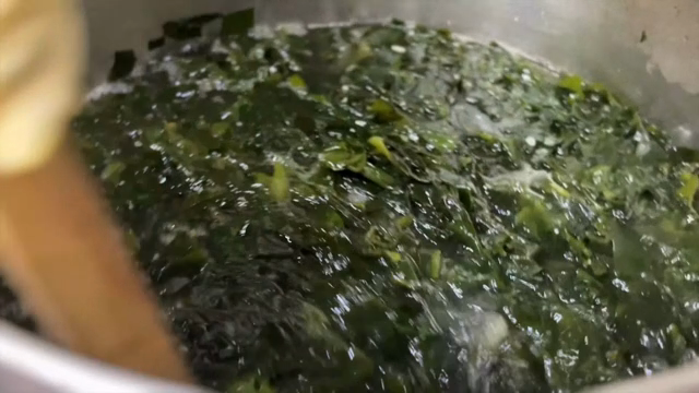 Seaweed soup being stirred in a pot