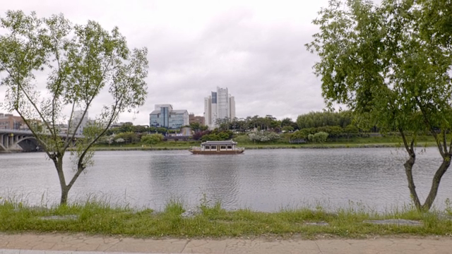 A river with a boat and city skyline