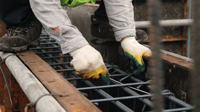 Worker tying rebar at a construction site
