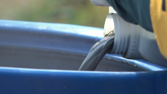 Liquid being poured into a blue container