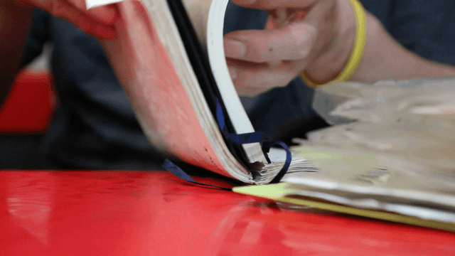 Person flipping through a notebook