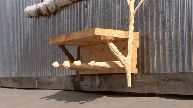 Wooden wall shelf mounted on a metal wall