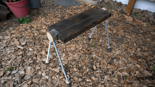 Handcrafted wooden bench placed on wooden pieces