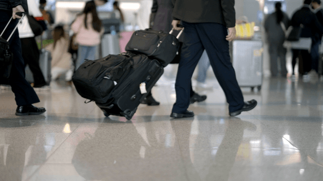 People walking with luggage in an airport