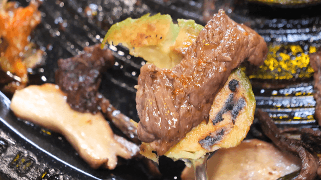 Grilled avocado and beef on a hot plate