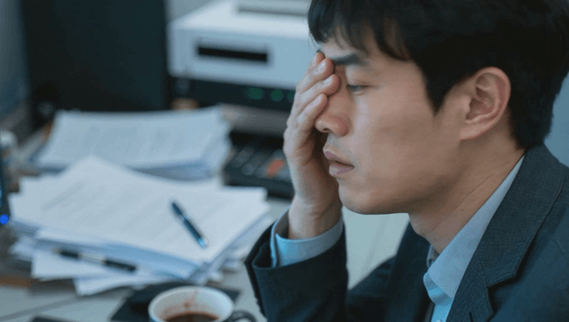 Office worker nervously working at desk