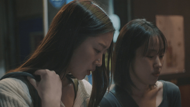 Two women looking down with concentration