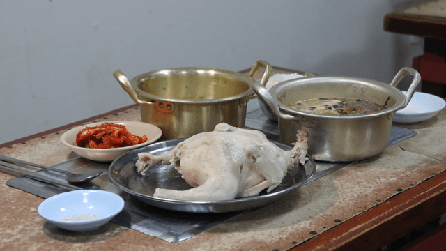 Table set with chicken soup and kimchi