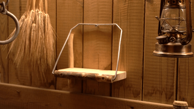 Hand placing a smartphone on a handcrafted wooden shelf