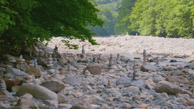 Quiet riverside with stacked stone towers
