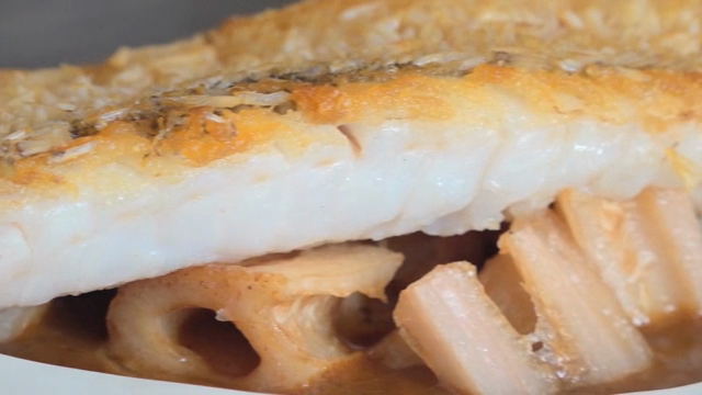 Grilled fish with crispy skin on a plate